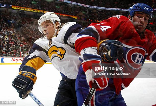 Roman Hamrlik of the Montreal Canadiens checks Maxim Afinogenov of the Buffalo Sabres during their NHL game at the Bell Centre December 20, 2008 in...