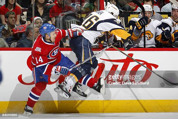Tomas Plekanec of the Montreal Canadiens is checked by Thomas Vanek of the Buffalo Sabres during their NHL game at the Bell Centre December 20, 2008...