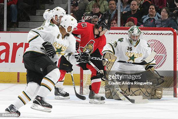 Antoine Vermette of the Ottawa Senators tips the puck on a shot from the point against Marty Turco of the Dallas Stars at Scotiabank Place on...