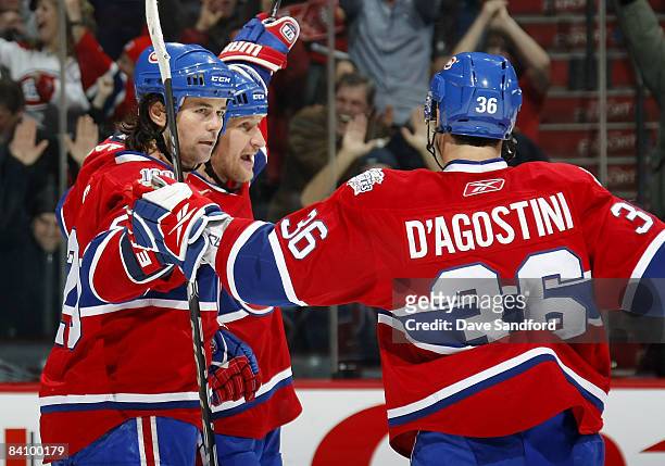 Alex Kovalev of the Montreal Canadiens celebrates his overtime winning goal against the Buffalo Sabres with teammates Robert Lang and Matt D'Agostini...