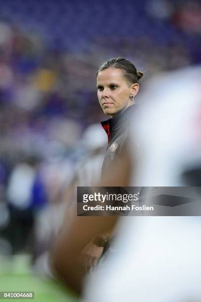 Assistant coach Katie Sowers of the San Francisco 49ers looks on during warmups before the preseason game on August 27, 2017 at U.S. Bank Stadium in...