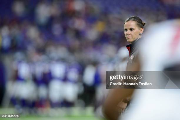 Assistant coach Katie Sowers of the San Francisco 49ers looks on during warmups before the preseason game on August 27, 2017 at U.S. Bank Stadium in...