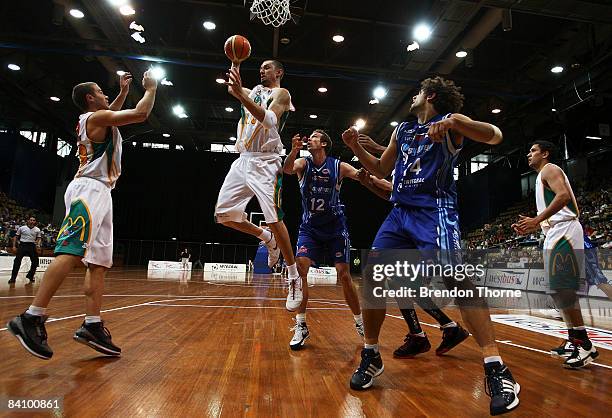 Russell Hinder of the Crocodiles gathers a rebound during the round 14 NBL match between the Sydney Spirit and the Townsville Crocodiles held at...