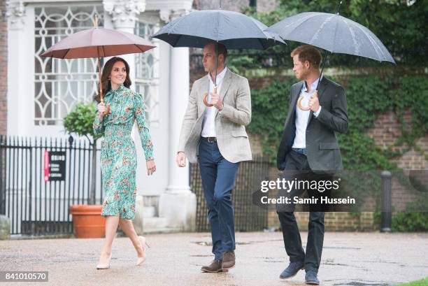 Prince William, Duke of Cambridge, Catherine, Duchess of Cambridge and Prince Harry visit The Sunken Garden at Kensington Palace on August 30, 2017...