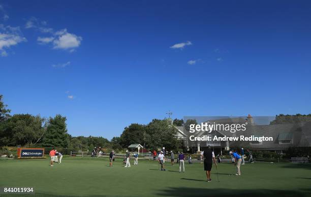 Players are pictured on the putting green in front of the clubhouse during practice for the Dell Technologies Championship on August 30, 2017 in...
