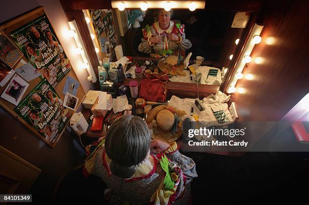 Chris Harris applies the finishing touches to his make-up in his dressing room backstage as he prepares for his role as Dame Trott in the production...