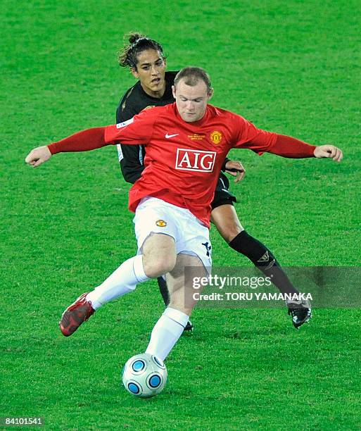 England's Manchester United forward Wayne Rooney battles for the ball with Ecuador's Liga de Quito defender Norberto Araujo during the first half of...