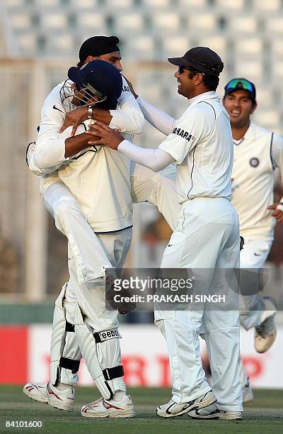 India cricketer Harbhajan Singh celebrates the wicket of England cricket captain Kevin Pietersen with Mahendra Singh Dhoni , Rahul Dravid and Yuvraj...
