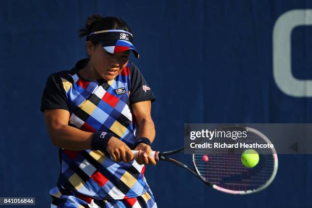 Risa Ozaki of Japan returns a shot against Danielle Lao of the United States during their first round Women's Singles match on Day Three of the 2017...