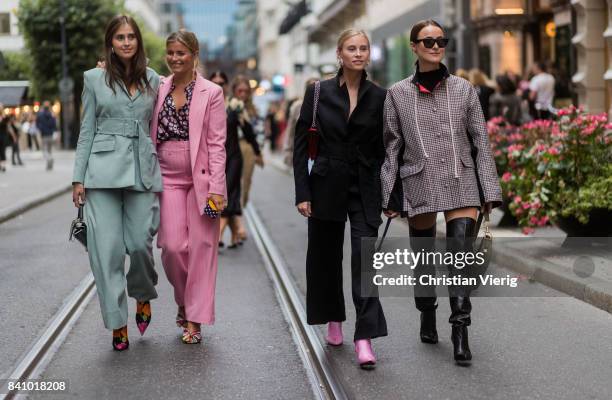 Guests wearing pastel suit, pink suit outside Rodebjer on August 30, 2017 in Stockholm, Sweden.