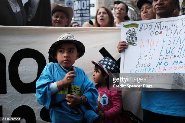 Two children join their parents and hundreds of immigration advocates and supporters at a rally and march to Trump Tower in support of the Deferred...