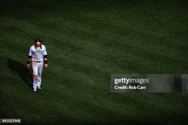 Taylor Motter of the Seattle Mariners walks back to the dugout after hitting into a double play to end the sixth inning against the Baltimore Orioles...