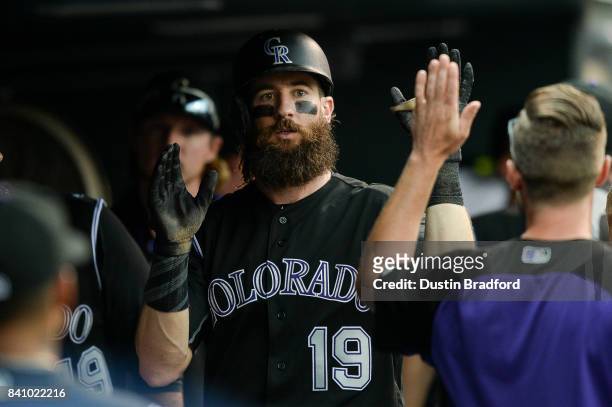 Charlie Blackmon of the Colorado Rockies celebrates in the dugout after hitting a sixth inning solo homerun against the Detroit Tigers at Coors Field...