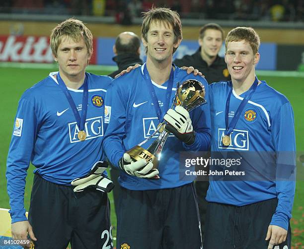 Tomasz Kuszczak, Edwin van der Sar and Ben Amos of Manchester United poses with the FIFA World Club Cup after the FIFA World Club Cup Final match...