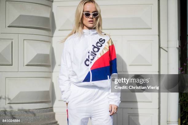 Guest wearing an Adidas track suit outside By Malina on August 30, 2017 in Stockholm, Sweden.