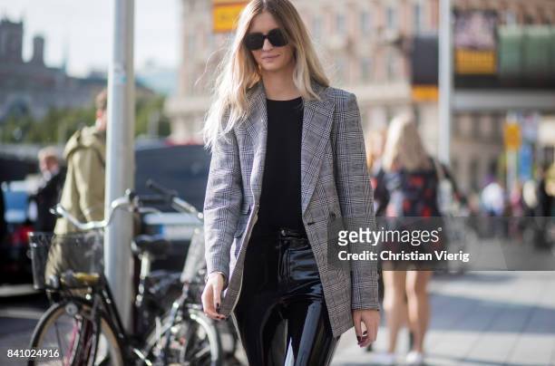 Guest wearing a grey blazer jacket, PVC pants outside By Malina on August 30, 2017 in Stockholm, Sweden.