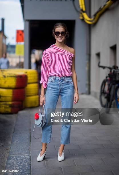 Nina Sandbech wearing an off shoulder top, denim jeans with Nina print outside By Malina on August 30, 2017 in Stockholm, Sweden.