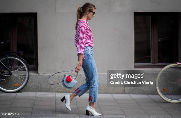 Nina Sandbech wearing an off shoulder top, denim jeans with Nina print outside By Malina on August 30, 2017 in Stockholm, Sweden.