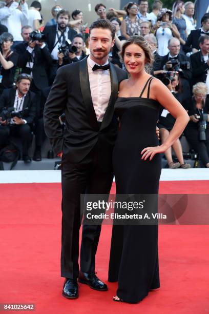 Maria Elena Boschi and her brother Emmanuel Boschi walk the red carpet ahead of the 'Downsizing' screening and Opening Ceremony during the 74th...