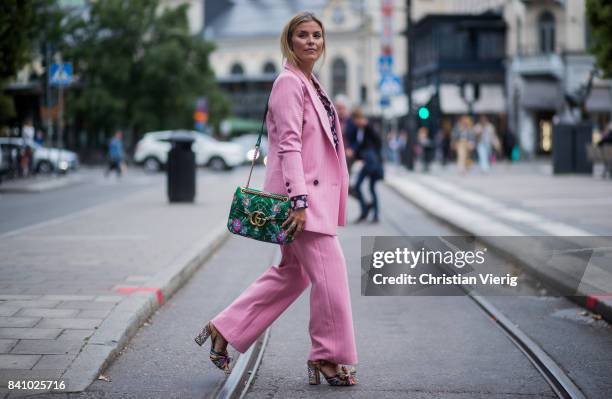 Janka Polliani wearing green Gucci bag, pink suit outside Rodebjer on August 30, 2017 in Stockholm, Sweden.