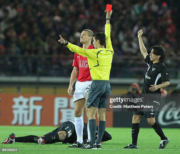 Nemanja Vidic of Manchester United is sent off by referee Ravshan Irmatov during the FIFA World Club Cup Final match between LDU Quito and Manchester...