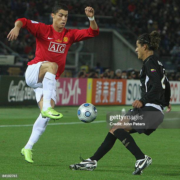 Cristiano Ronaldo of Manchester United clashes with Norberto Araujo of LDU Quito during the FIFA World Club Cup Final match between LDU Quito and...