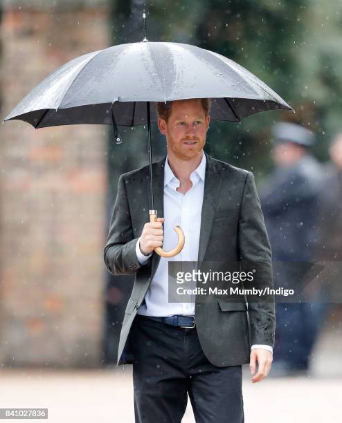 Prince Harry arrives to view tributes to Diana, Princess of Wales left at the gates of Kensington Palace after visiting the Sunken Garden on August...