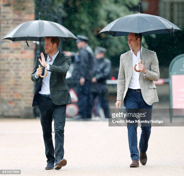 Prince Harry and Prince William, Duke of Cambridge arrive to view tributes to Diana, Princess of Wales left at the gates of Kensington Palace after...