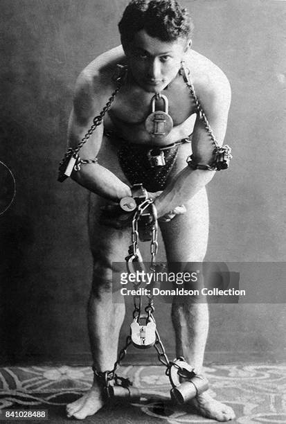 Hungarian-American escape artist and illusionist, Harry Houdini in handcuffs, elbow irons and thumbscrews, courtesy of the Berlin police, Germany,...