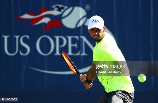 Thomaz Bellucci of Brazil returns a shot to Dustin Brown of Germany during their first round Men's Singles match on Day Three of the 2017 US Open at...