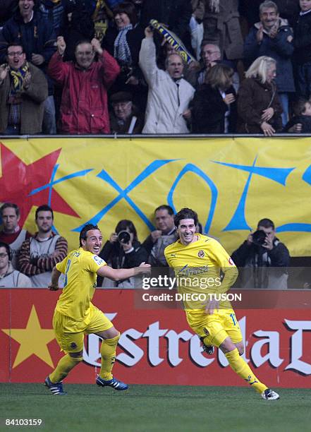 Villarreal's Cani celebrates after scoring a goal with teammate Santi Cazorla during their Spanish league football match against Barcelona at...