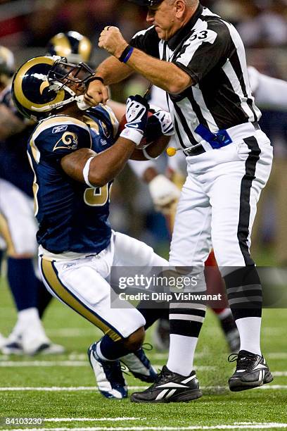 Kenneth Darby of the St. Louis Rams runs into umpire Garth DeFelice against the San Francisco 49ers at the Edward Jones Dome on December 21, 2008 in...