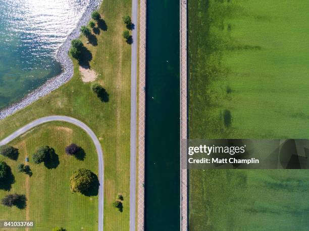 aerial of canal leading to open water - lake auburn photos et images de collection