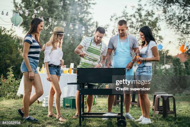 outdoor party - couple grilling stock pictures, royalty-free photos & images