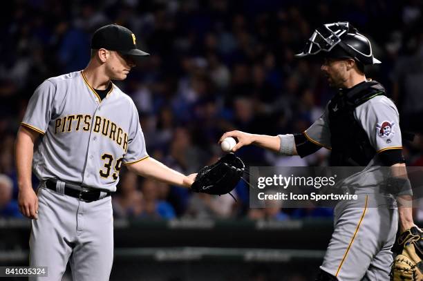 Pittsburgh Pirates starting pitcher Chad Kuhl is handed the ball by Pittsburgh Pirates catcher Chris Stewart after giving up a run in the inning...