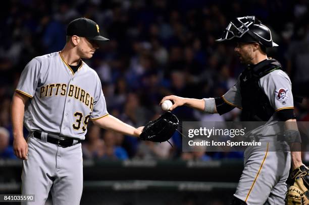 Pittsburgh Pirates starting pitcher Chad Kuhl is handed the ball by Pittsburgh Pirates catcher Chris Stewart after giving up a run in the inning...