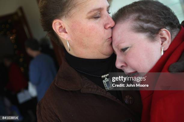 Suzie Xavier , is comforted by her friend Ronda Woodgeared following a prayer service at the Wilmington Church of God December 21, 2008 in...