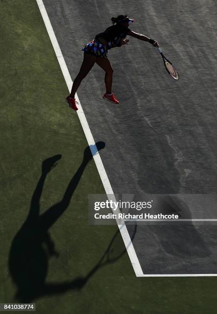 Risa Ozaki of Japan serves against Danielle Lao of the United States during their first round Women's Singles match on Day Three of the 2017 US Open...