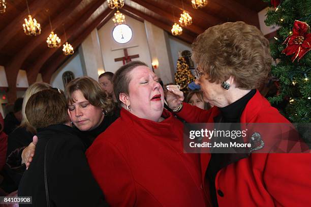 Suzie Xavier , is blessed by pastor Elizabeth Looney following a prayer service at the Wilmington Church of God December 21, 2008 in Wilmington,...