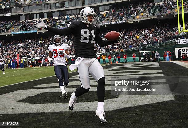 Chaz Schilens of the Oakland Raiders celebrates scoring a touchdown past Jacques Reeves of the Houston Texans during an NFL game on December 21, 2008...