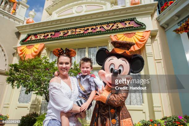 In this handout photo provided by Disney Resorts, actress Alyssa Milano and son, Milo Bugliari, visit the Magic Kingdom Park at Walt Disney World on...
