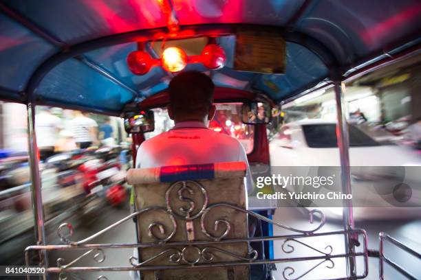 tuk-tuk in motion in bangkok at night - rickshaw or tuk tuk or surrey or pedicab stock pictures, royalty-free photos & images