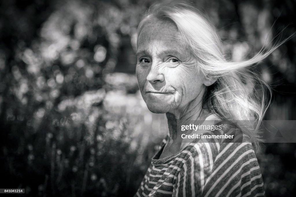 Black and white portrait of attractive mature woman, copy space