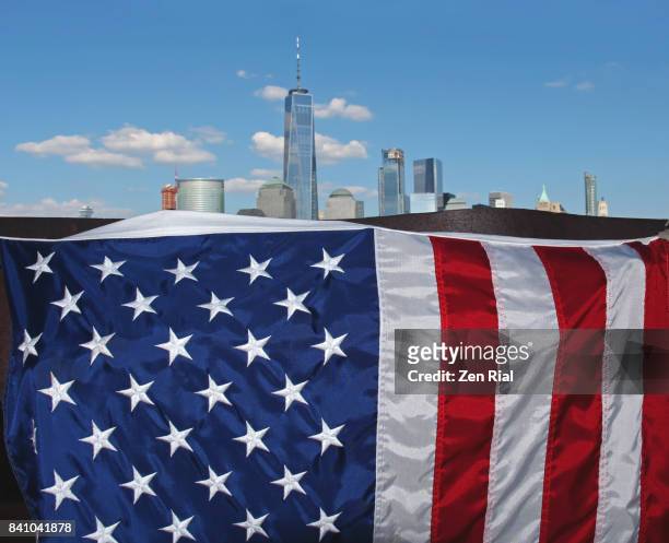 close-up of the american flag with lower manhattan skyline in the background - skyline stitched composition stock pictures, royalty-free photos & images