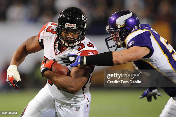 Michael Turner of the Atlanta Falcons carries the ball during an NFL game against the Minnesota Vikings at the Hubert H. Humphrey Metrodome, on...