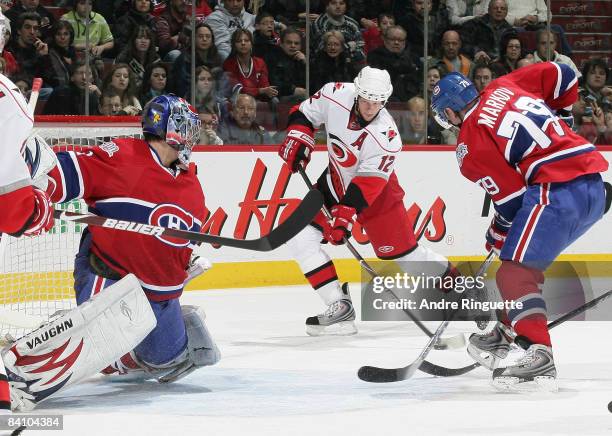 Eric Staal of the Carolina Hurricanes scores a power play goal against Carey Price and Andrei Markov of the Montreal Canadiens at the Bell Centre on...