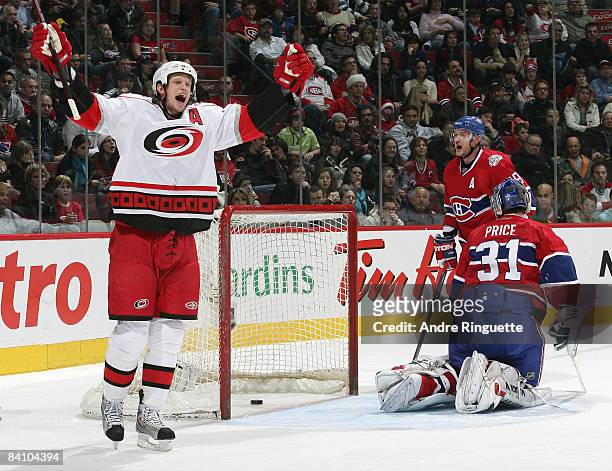 Eric Staal of the Carolina Hurricanes raises his arms to celebrate his second period power play goal against Andrei Markov and Carey Price the...