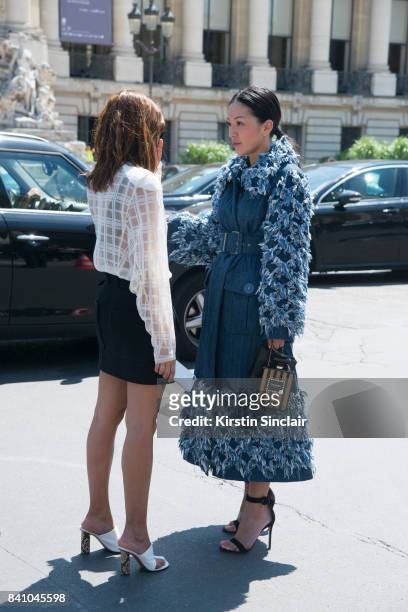 Vogue Australia senior fashion editor Christine Centenera wears a Chanel top and skirt and Celine shoes with Fashion Stylist Tina Leung wearing a...