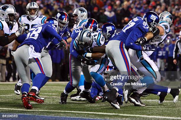 Running back DeAngelo Williams of the Carolina Panthers breaks a tackle to score a touchdown against the New York Giants on December 21, 2008 at...