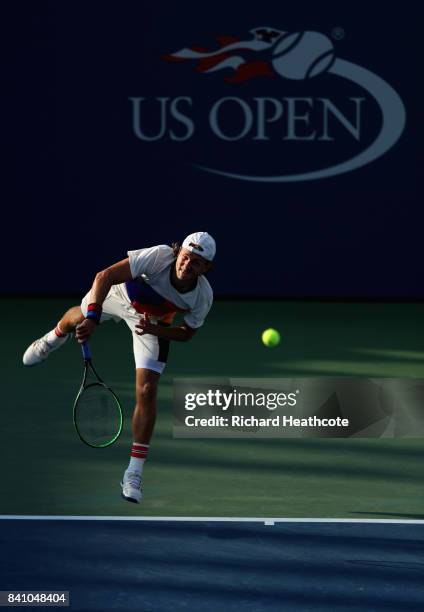 Lucas Pouille of France serves against Jared Donaldson of the United States during their second round Men's Singles match on Day Three of the 2017 US...